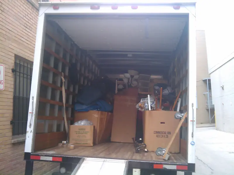 The back of a removal lorry loaded with boxes and furniture